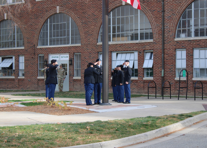 MSU ROTC Cadets saluting an American flag.